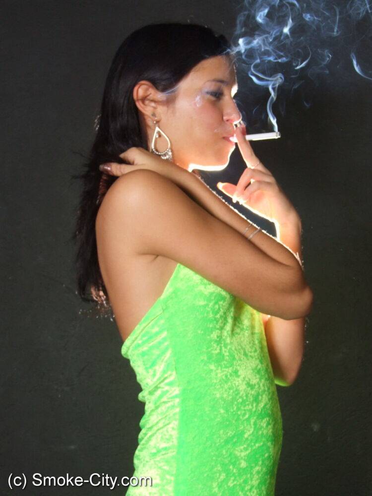 Dark haired teen wears a lime dress and pointy heels while smoking - #6