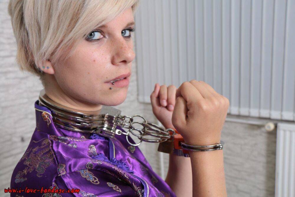 Short haired girl with piercings is restrained with cuffs wearing a kimono - #1