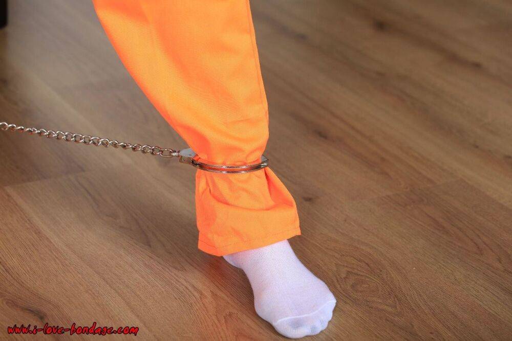 Female prisoner is left alone while cuffed in an orange jumper and white socks - #7