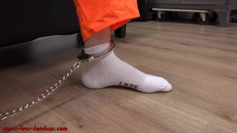 Female prisoner is left alone while cuffed in an orange jumper and white socks - #16