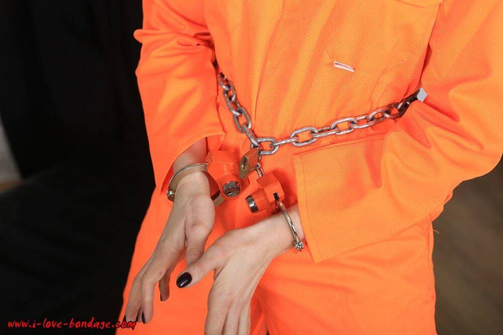 Female prisoner is left alone while cuffed in an orange jumper and white socks - #14