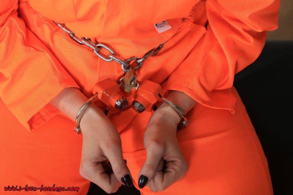 Female prisoner is left alone while cuffed in an orange jumper and white socks - #8