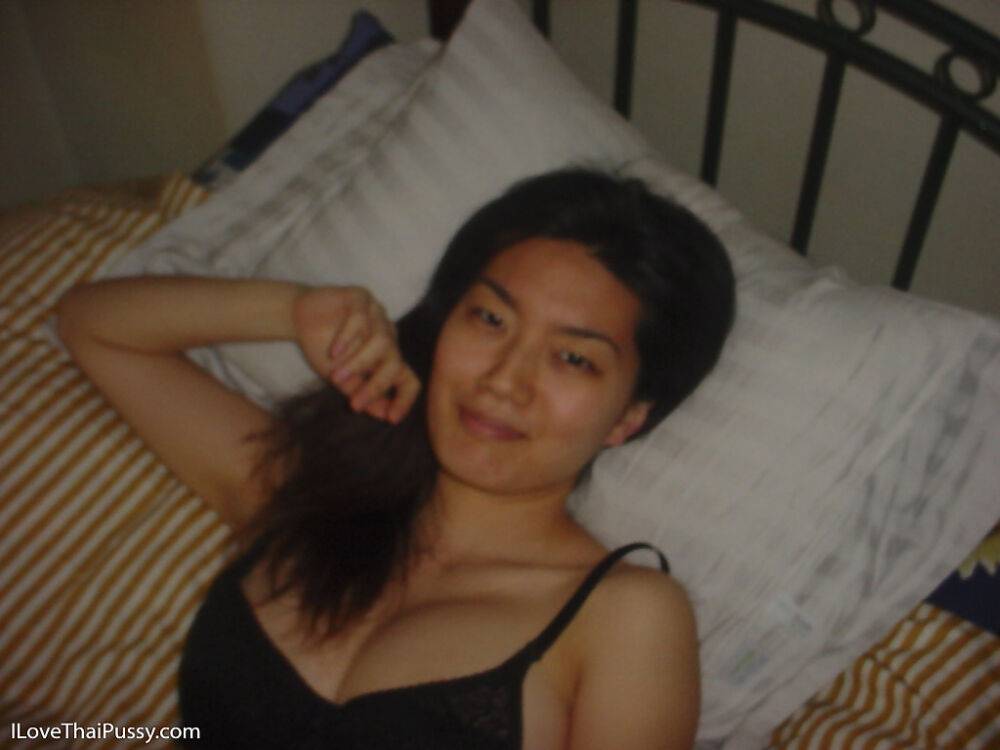 Seductive asian babe slipping off her clothes and showing off her big tits - #1