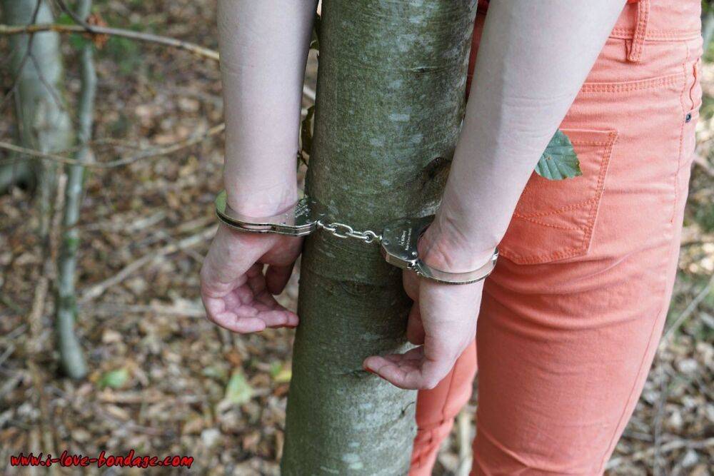 Clothed girl in canvas sneakers finds herself handcuffed to a tree in woods - #3