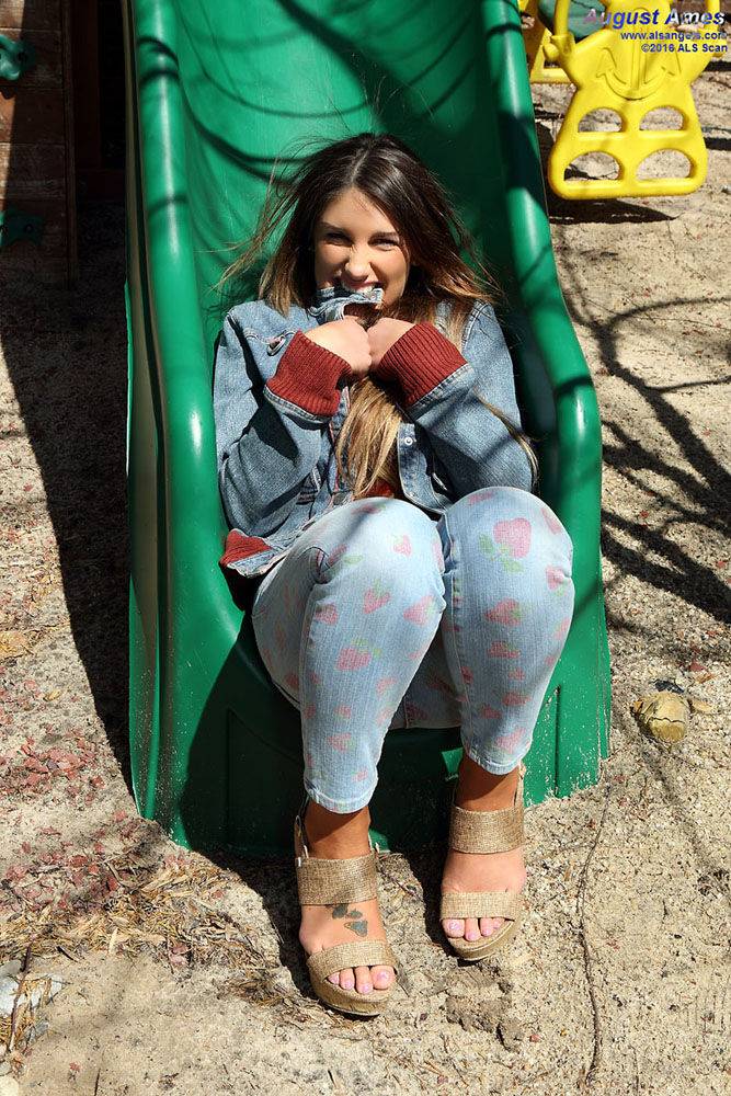 Busty amateur female August Ames spreading pussy lips apart on swing set - #1