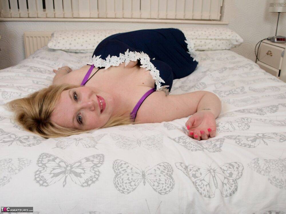 Blonde amateur Sindy Bust looses her big tits while disrobing to stockings - #9