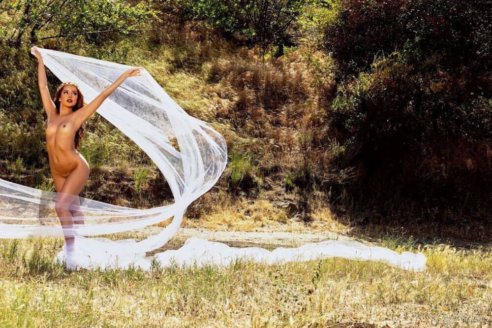 Gorgeous redhead Vanna Bardot models under a tree during a centerfold shoot - #5