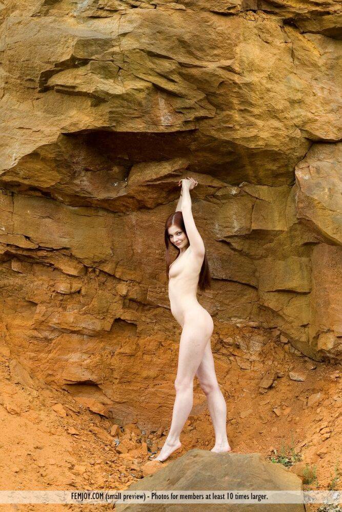 Pale girl with long red hair Angelina B poses totally naked afore a cliff - #2