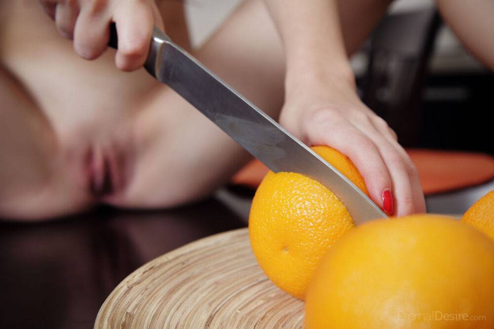 Young beauty Amelie B slices oranges before licking a knife in the nude - #14