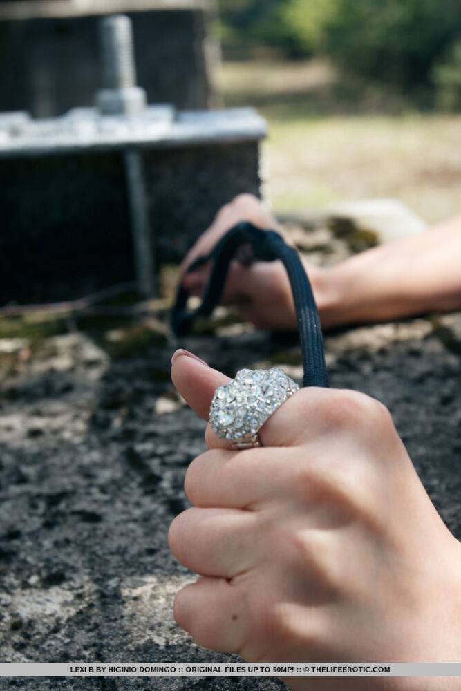 Fetish girl Lexi B in leather straps and chains squatting to piss outdoors - #7