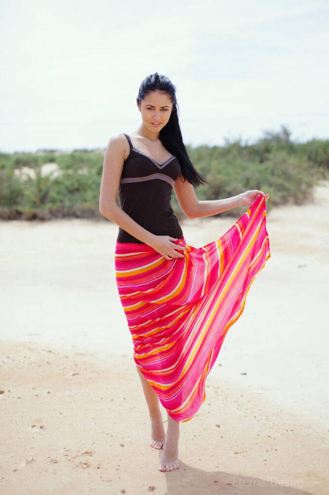 White teen with black hair dresses herself after modeling naked on a beach - #7