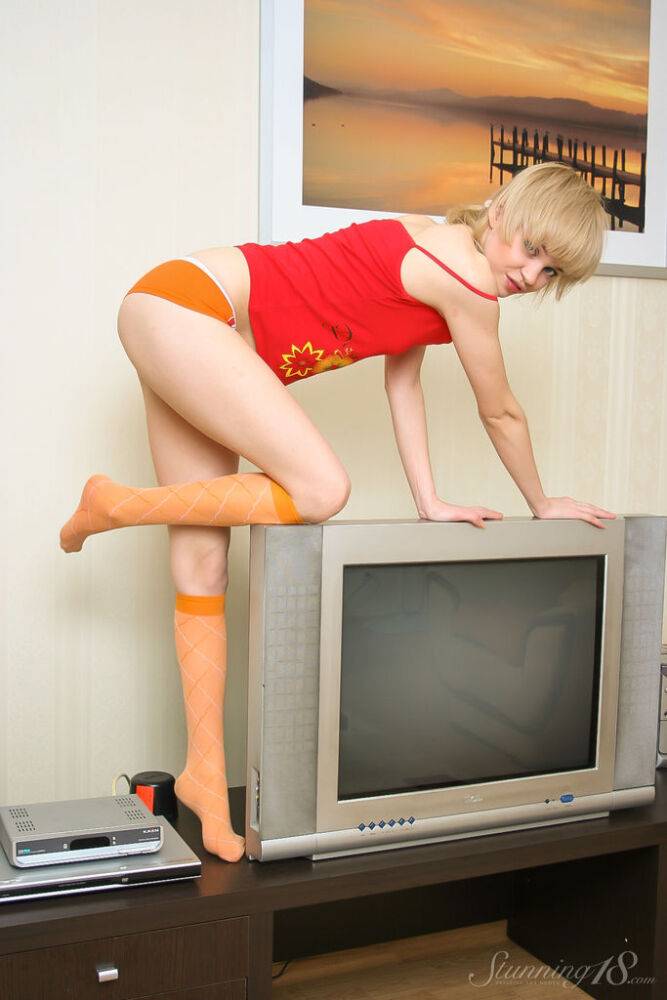 Cute blonde teen Cindy B gets naked in orange knee socks in a playful manner - #6