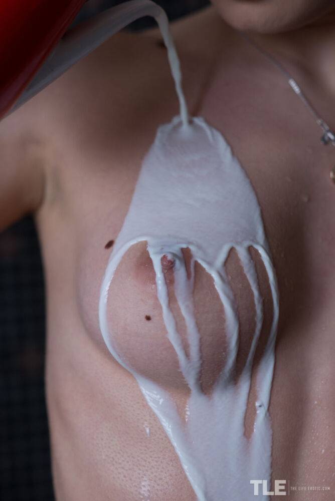 Naked model Katia B pours milk over her clear skin before rinsing it off - #6