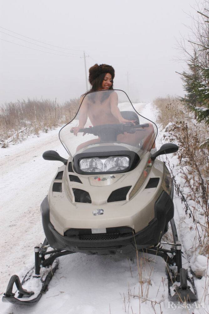Young brunette Lilian poses in the nude on top of a snowmobile in the winter - #5