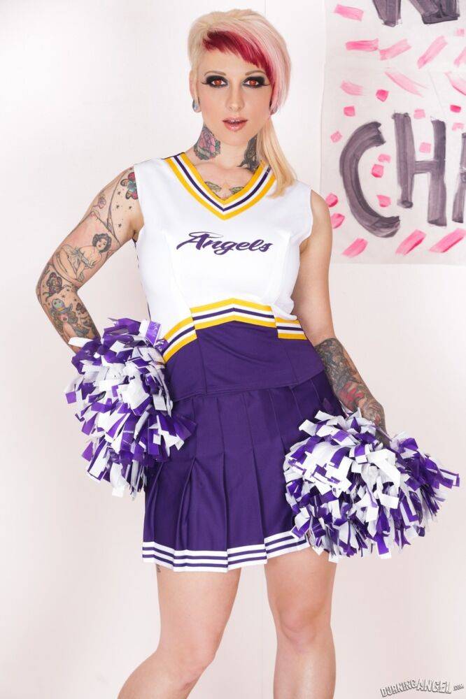 Tattooed chick Scarlet Lavey works free of a cheerleader outfit to pose naked - #1