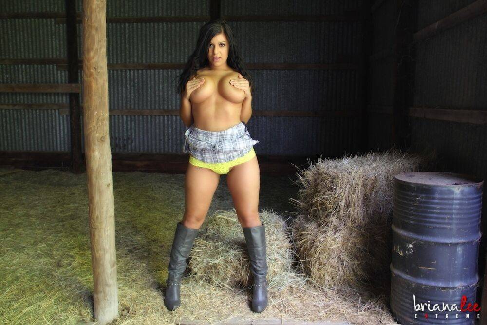 Thick girl Briana Lee strips to leather boots against a post in the hay room - #2