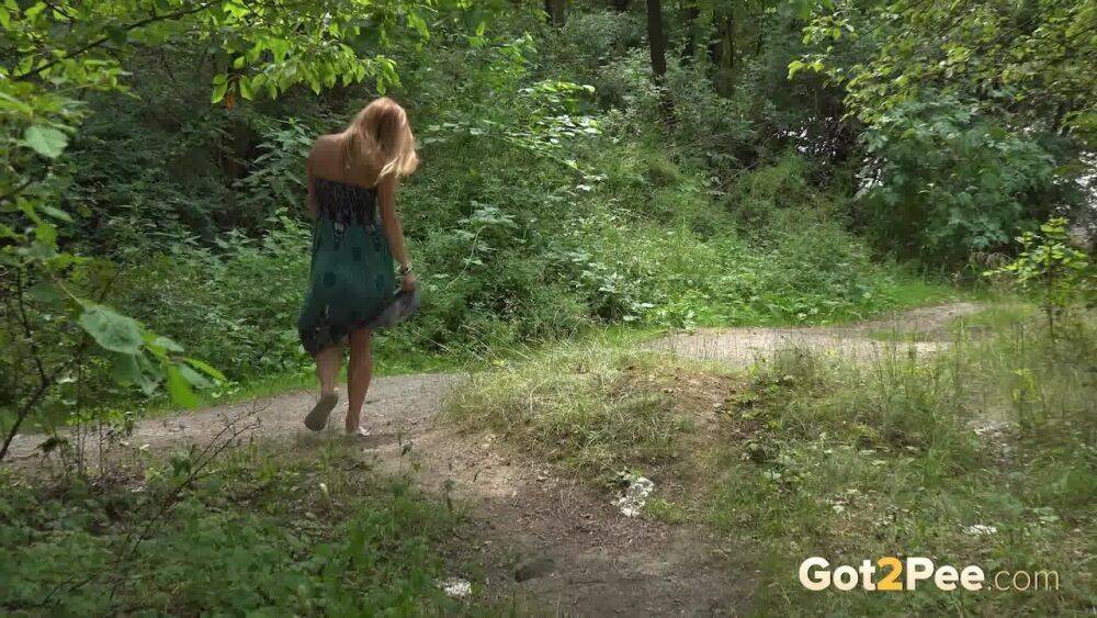 Caucasian chick Chrissy Fox squats for a piss on a path through the woods - #12