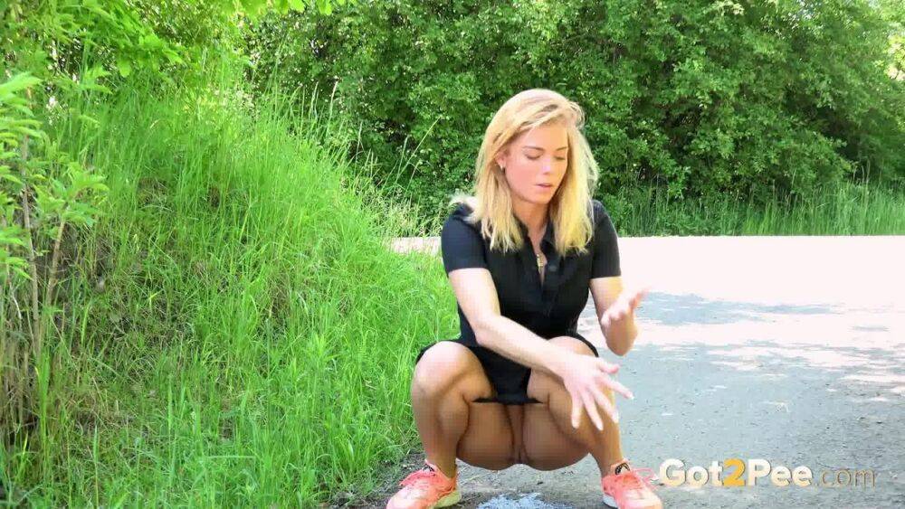 Blonde Chrissy squats to take a pee in the middle of the walking path - #13