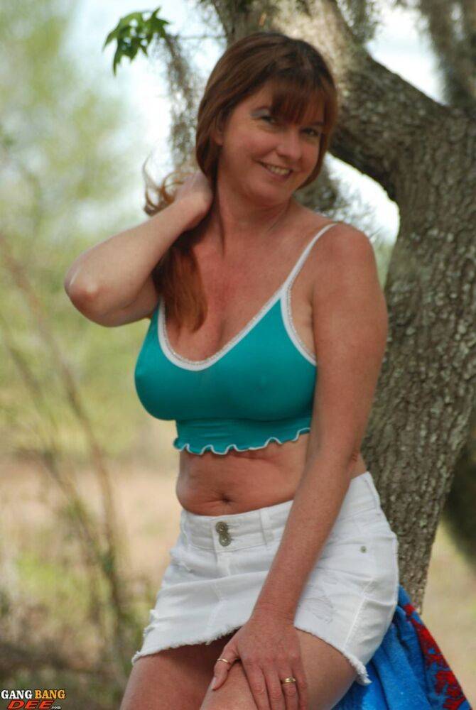 Mature lady Dee Delmar pets her snatch after stripping in the woods - #1