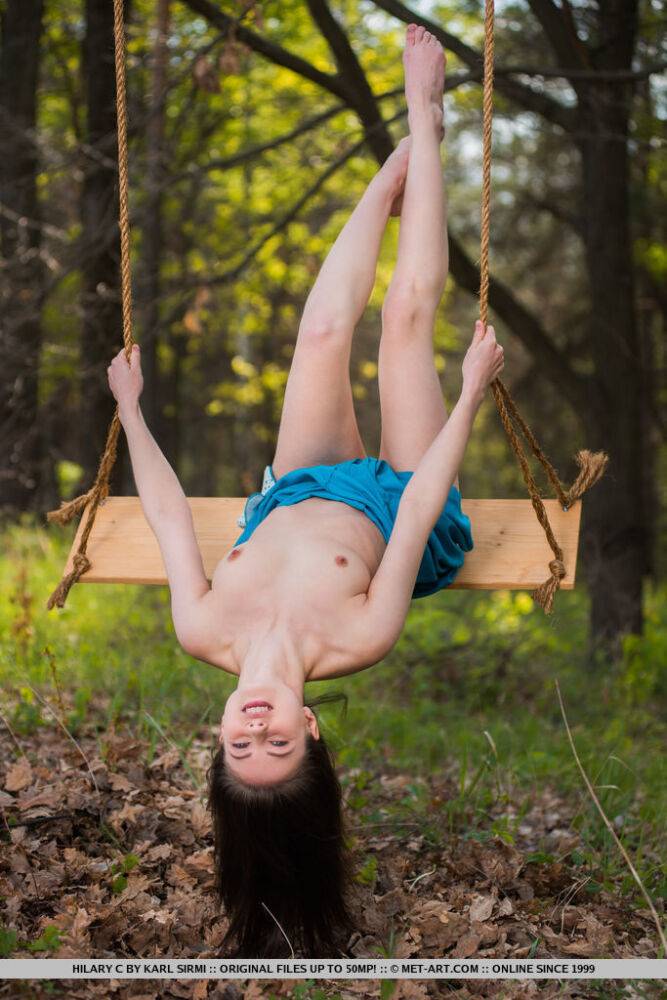 Young brunette Hilary C is encouraged to get naked on swing set in forest - #2