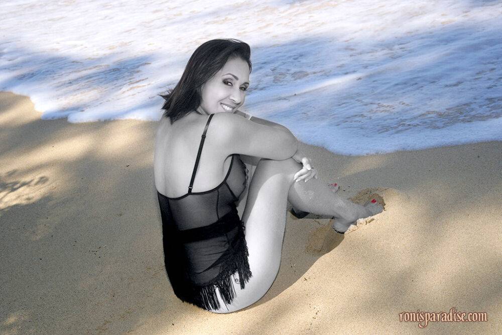 Long legged mature Roni posing on the beach in black lacy pantyhose - #13