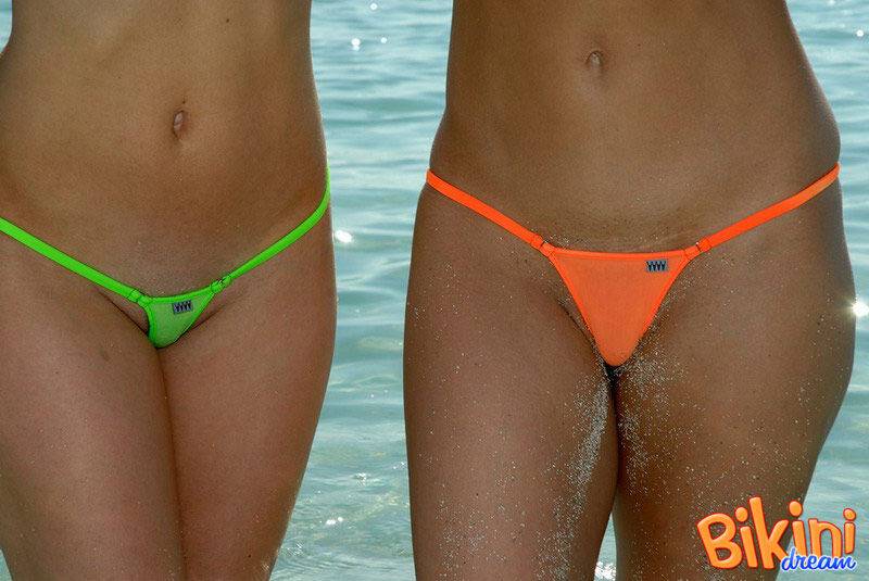 Lesbian girls show her sand covered asses while modeling thong bikinis - #12