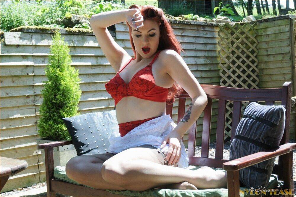 Redhead model Amber proudly shows her nice tits on a deck in retro pretties - #8