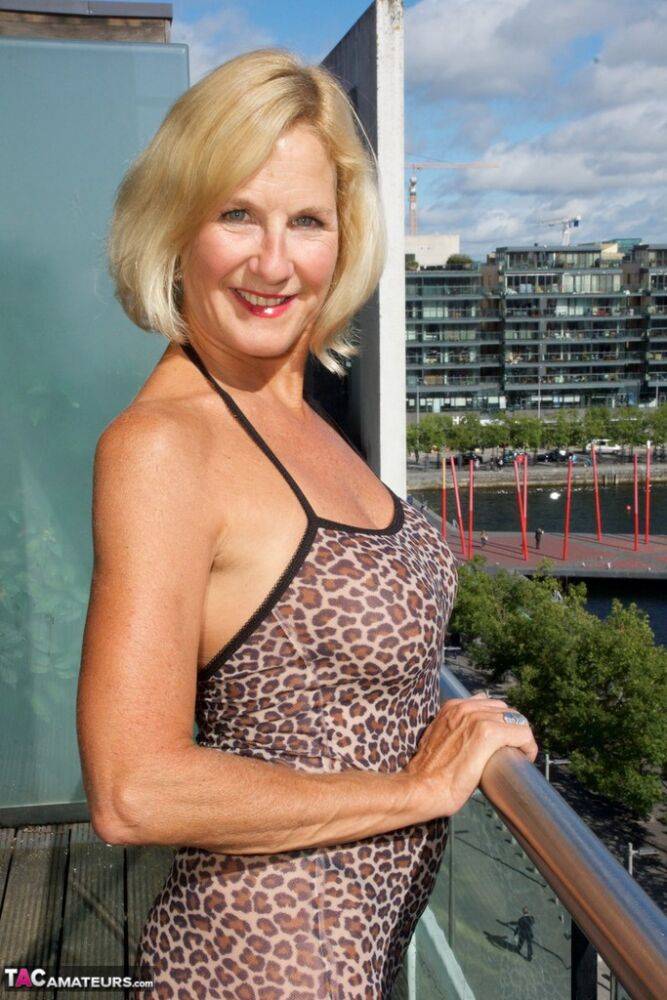 Older blonde woman Molly MILF exposes her tits and twat on condo balcony - #16