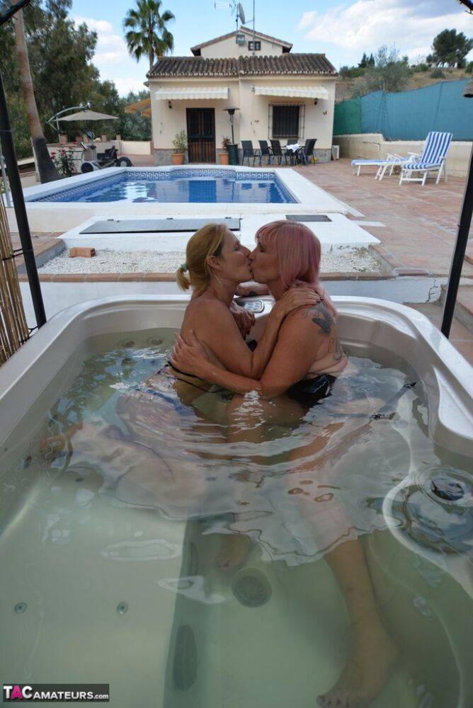 Mature lesbians with big tits kiss in a hot tub before licking pussy - #5