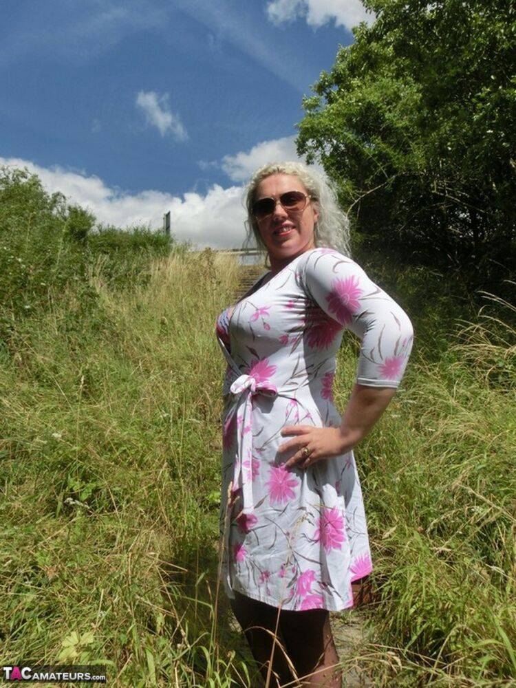 Older platinum blonde Barby strips to garters and nylons in the countryside - #7