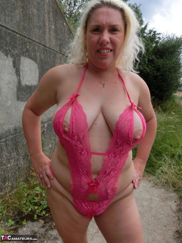 Mature blonde Barby shows her big tits and bald twat while changing clothing - #10