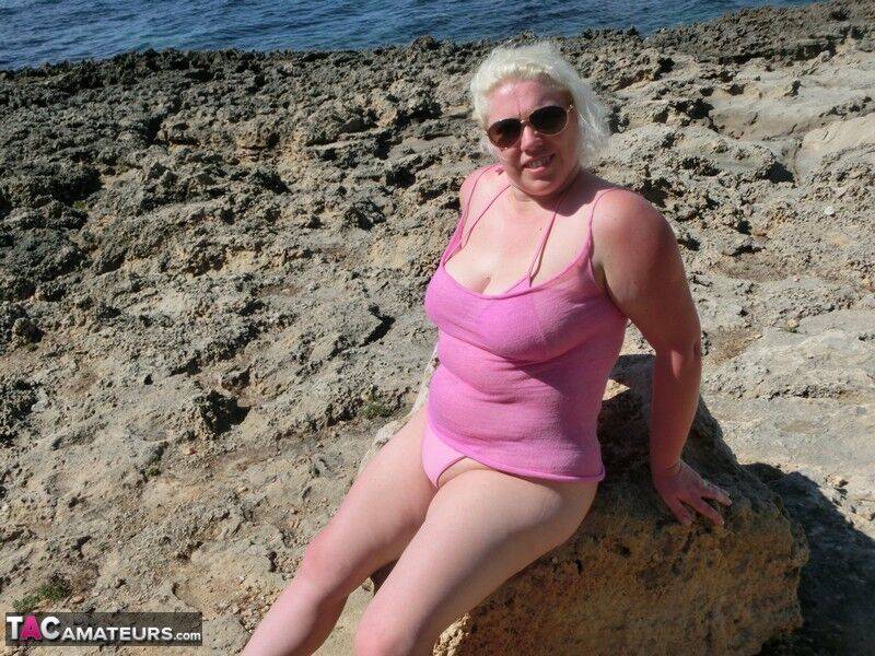 Chubby older blonde Barby gets naked in shades near the ocean - #13