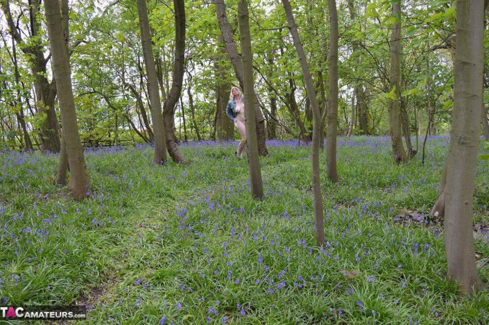 Blonde amateur Barby Slut gets naked in the woods amongst wild flowers - #16