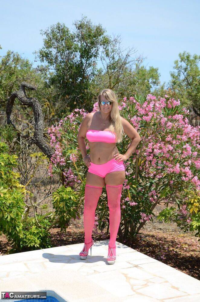 Over 30 blonde Sweet Susi gets naked beside a pool in pink hosiery and shades - #14