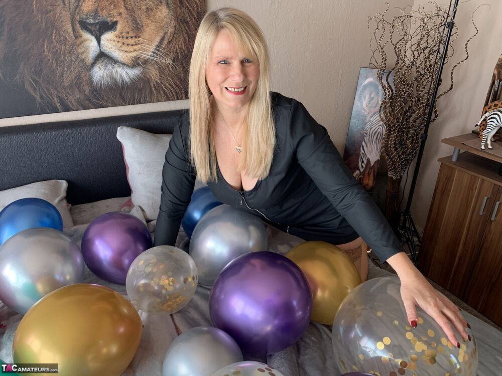 Middle-aged blonde Sweet Susi gets naked on her bed amid balloons - #2