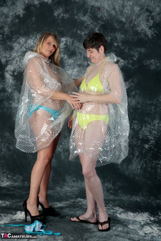 Blonde amateur Sweet Susi and her lesbian lover hump each other in raincoats | Photo: 1330617