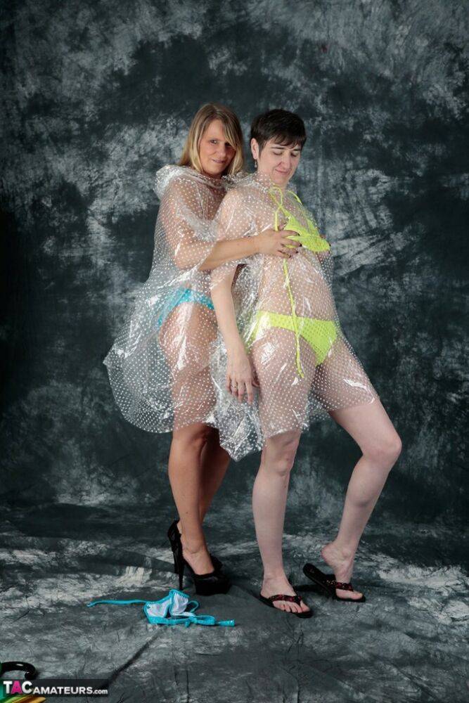 Blonde amateur Sweet Susi and her lesbian lover hump each other in raincoats | Photo: 1330588