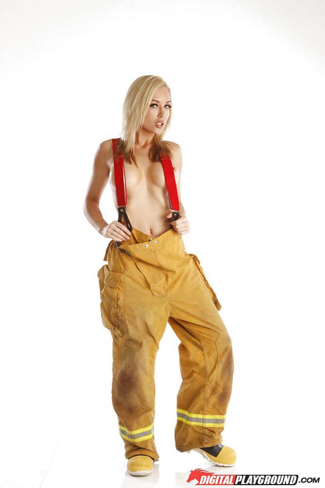 Skinny blonde babe is revealing her tremendous body in a fireman uniform - #16