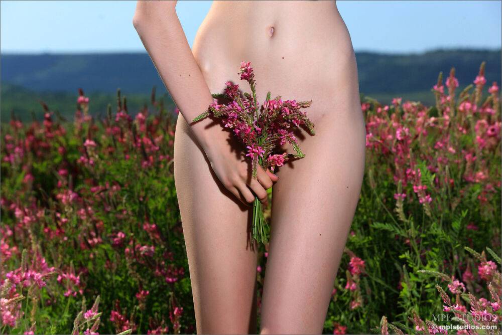 Skinny teen girl spreading naked pussy in a field while picking flowers - #2