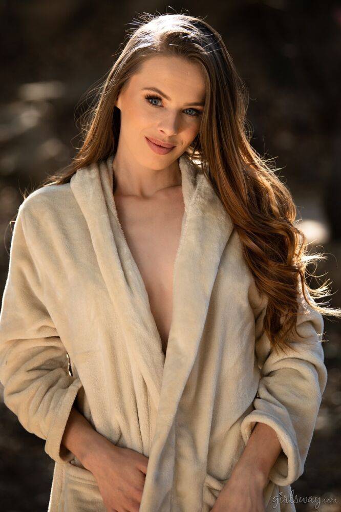Beautiful girl removes a bathrobe to model naked on a boulder while outdoors - #2