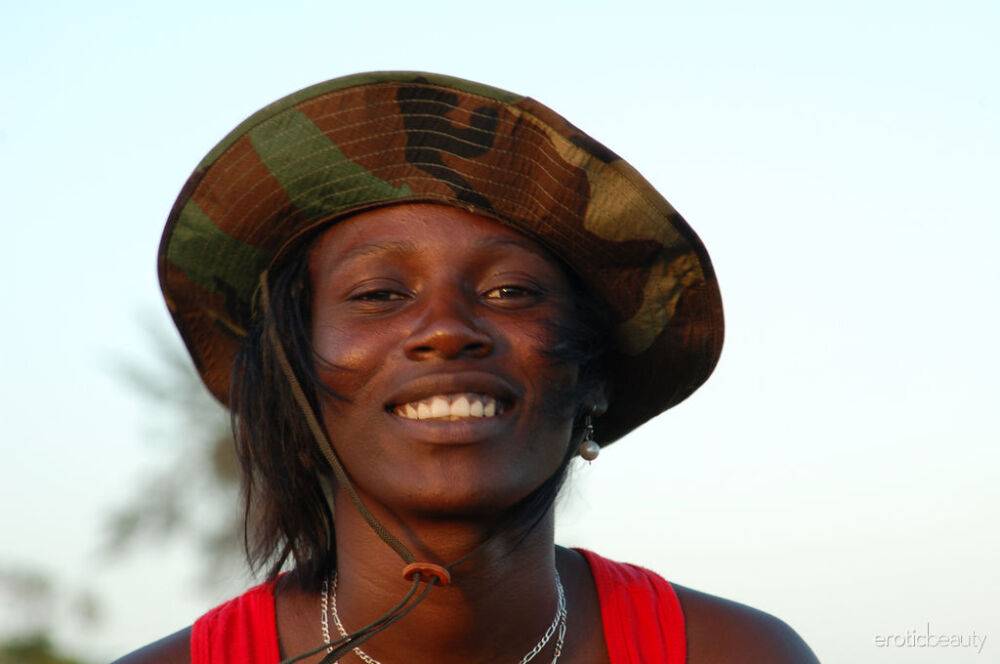 Black girl Maria L displays her naked body in a field near the sea - #2