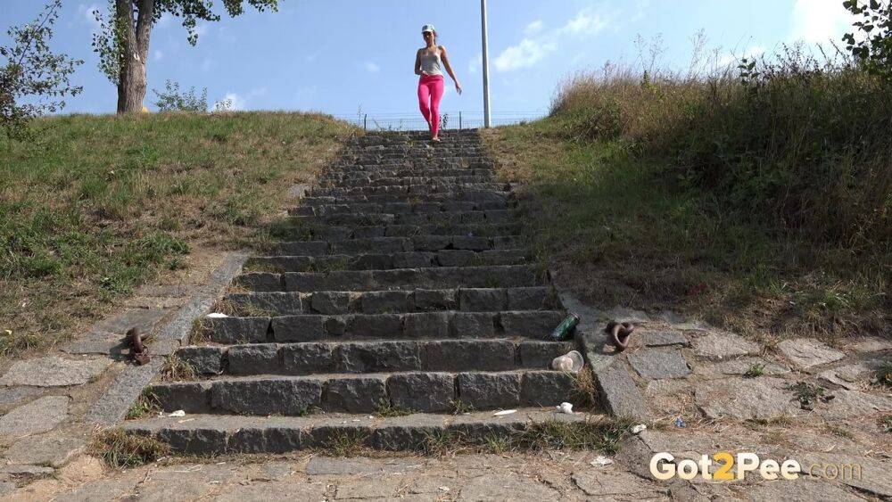 Distressed female Kayla pulls down pink leggings to pee on stone steps - #15