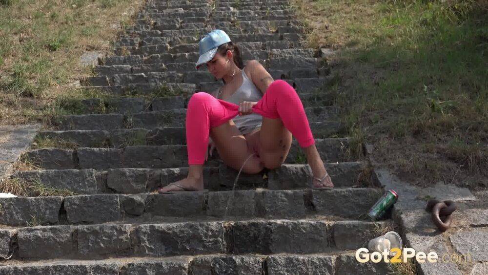 Distressed female Kayla pulls down pink leggings to pee on stone steps - #10