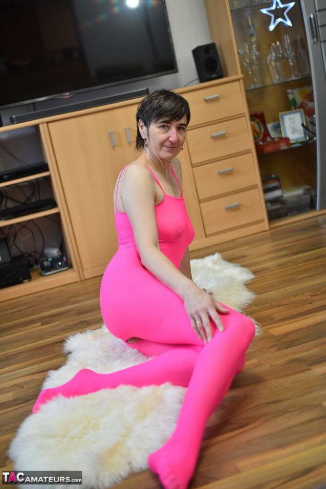 Mature amateur Hot MILF takes off a crotchless pink bodystocking atop a rug - #11