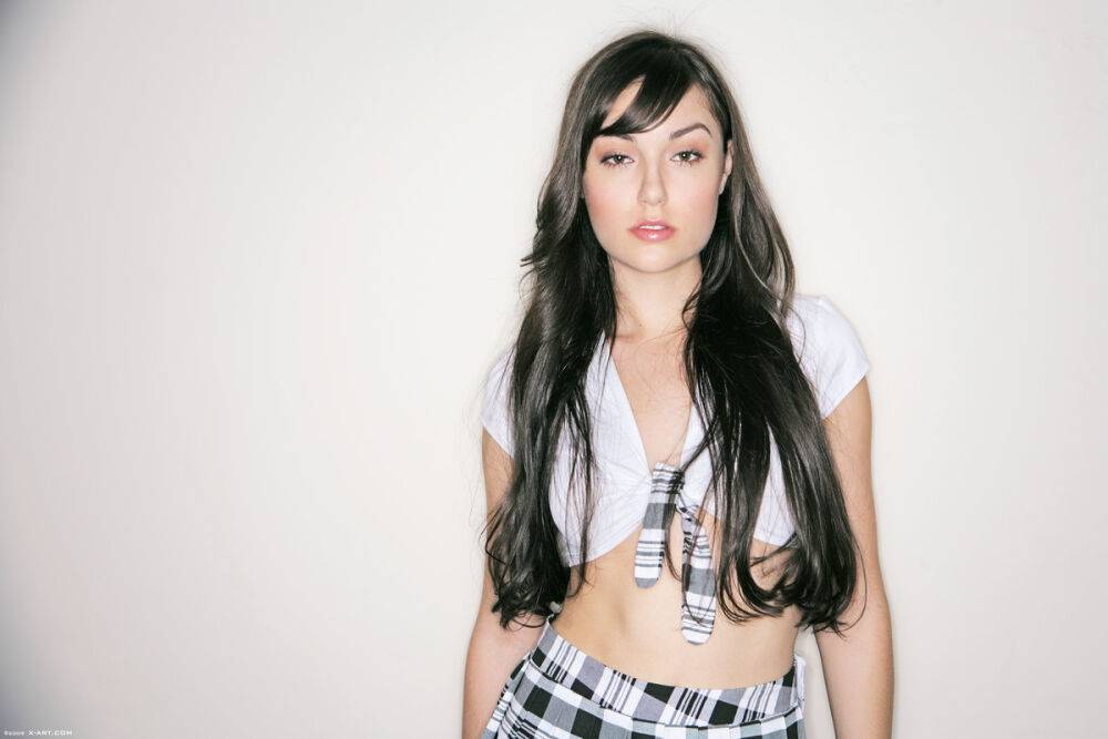 Solo model Sasha Grey removes her top in a pleated skirt and stockings - #13