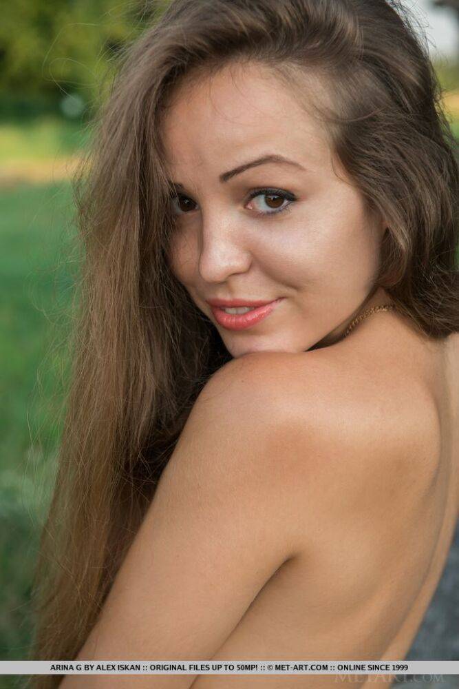 Young sweetie Arina G revealing freshly trimmed bush outdoors in the grass - #16