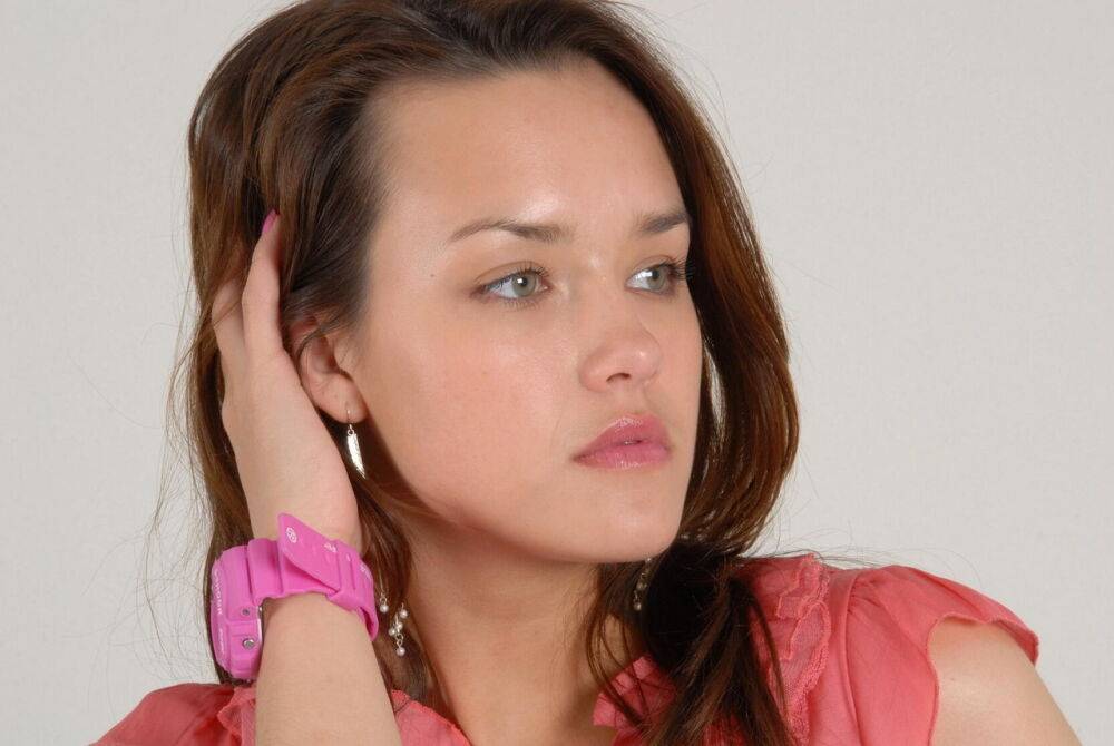 Caucasian female Alice admires her pink G-Shock watch while fully clothed - #4