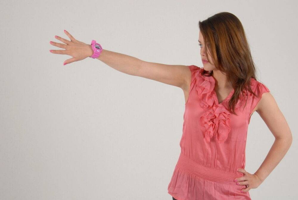 Caucasian female Alice admires her pink G-Shock watch while fully clothed - #6