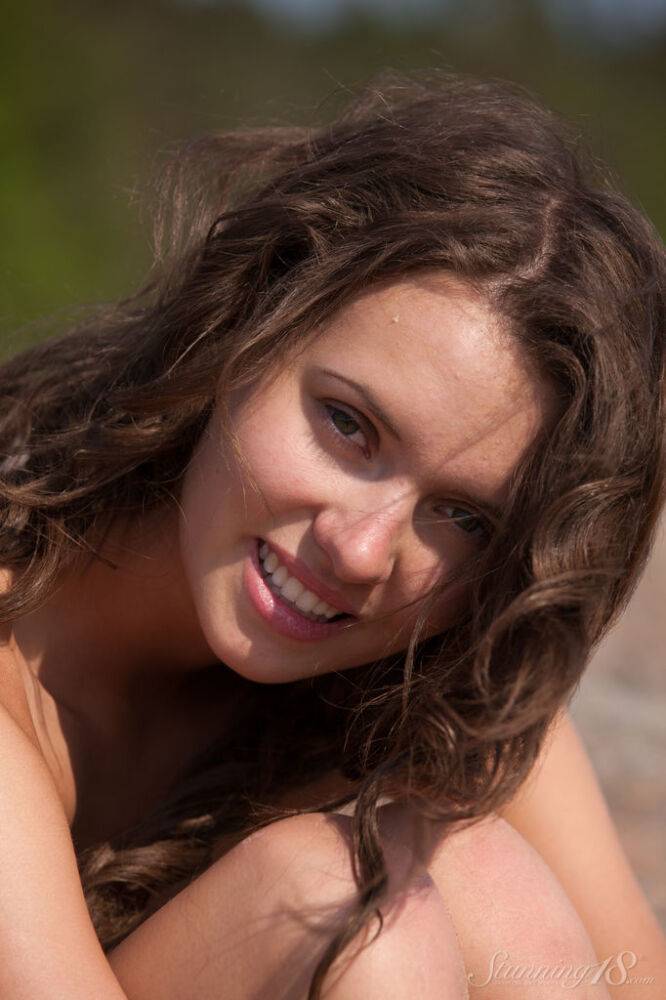 18-year-old girl Lucy G removes her bikini to model naked on seaside boulders - #11