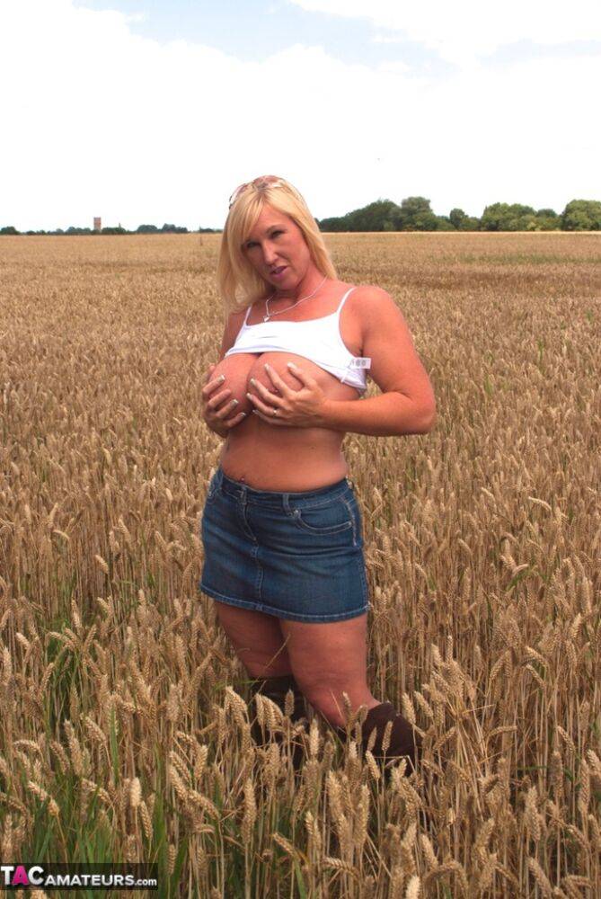 Chubby mature MILF Melody reveals great big tits & flashes hot ass in a field - #9